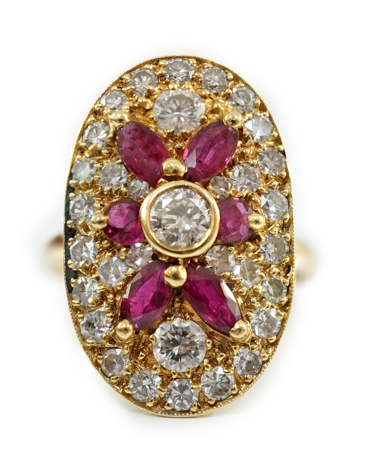 A modern gold, ruby and diamond set oval cluster ring